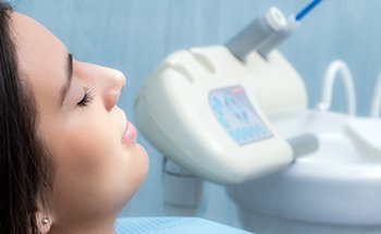 Woman with eyes closed in dental chair