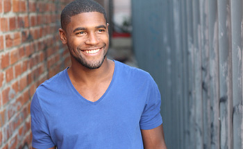 Young man in blue shirt smiling