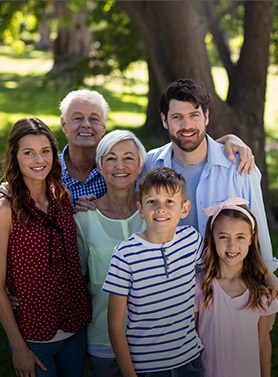 Three generations of family smiling outdoors