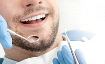 A man getting a dental checkup and cleaning