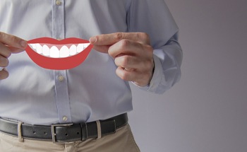 Man holding an image of a smile