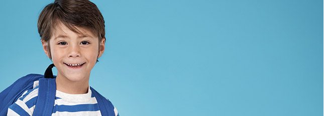 Smiling young boy with backpack