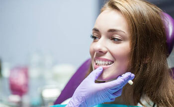 Woman receiving dental exam before gum disease treatment in Woodstock