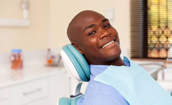 Man in dental chair smiling