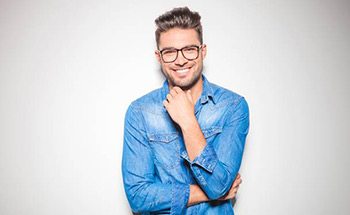 Man in denim shirt smiling