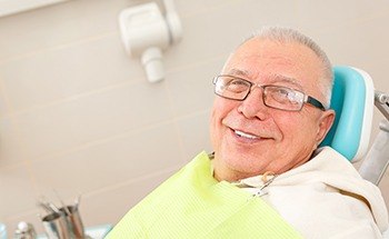 Smiling senior man in dental chair