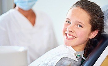 Smiling girl in dental chair