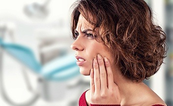 Woman holding jaw in pain