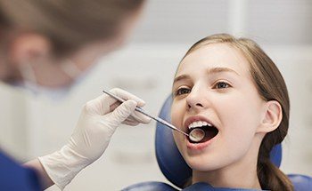 Little girl receiving dental exam