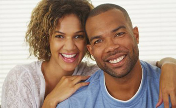 Couple embracing while smiling