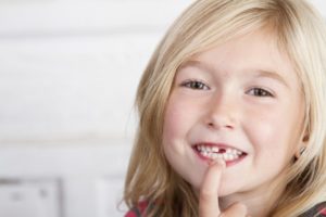 girl pointing to teeth