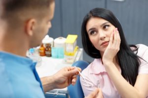 woman pain dentist chair